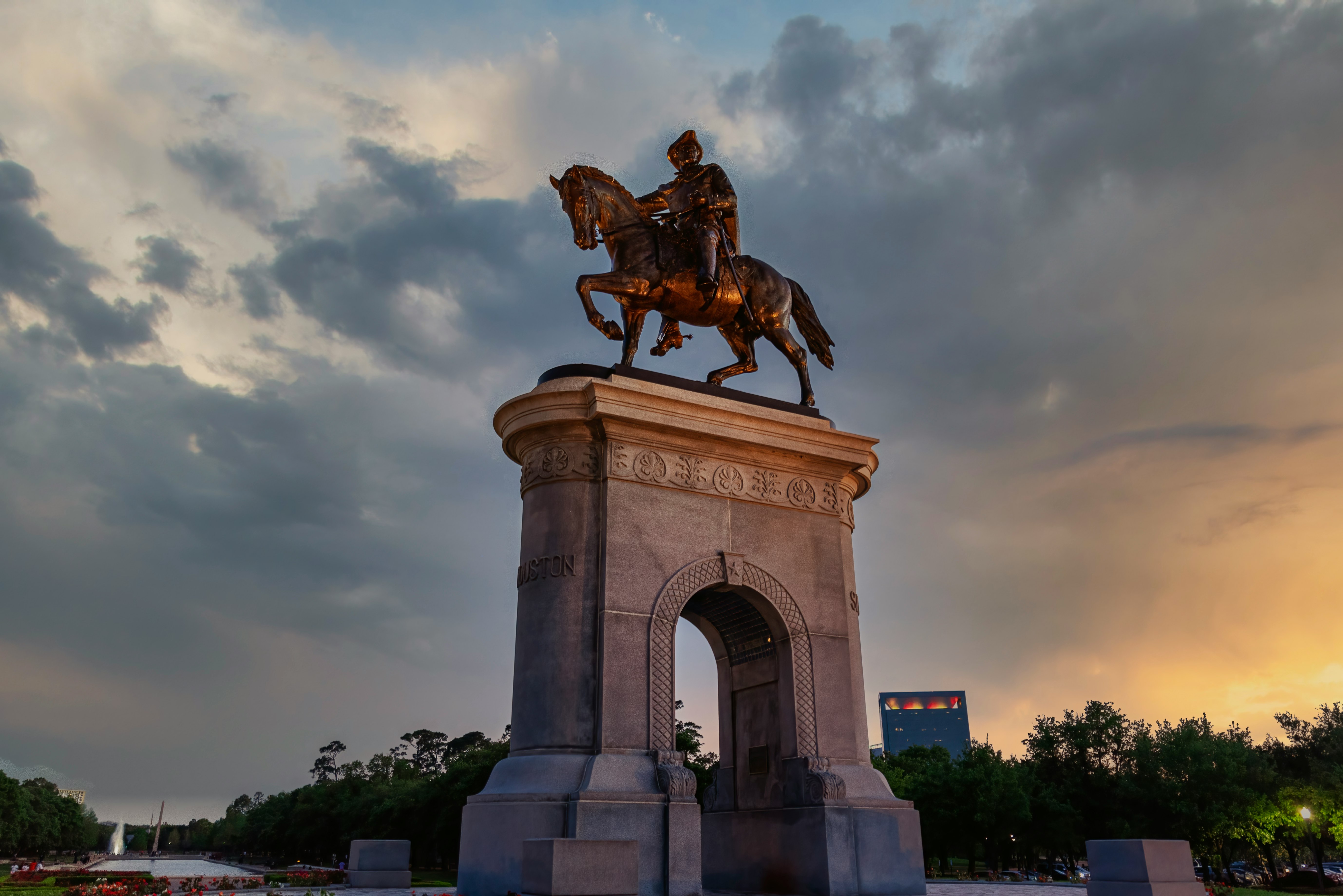 man riding horse statue under cloudy sky during daytime